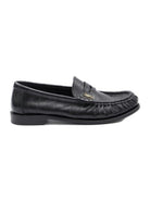 Black leather loafers featuring a classic slip-on design and stylish tassel detail, perfect for both formal and casual occasions 